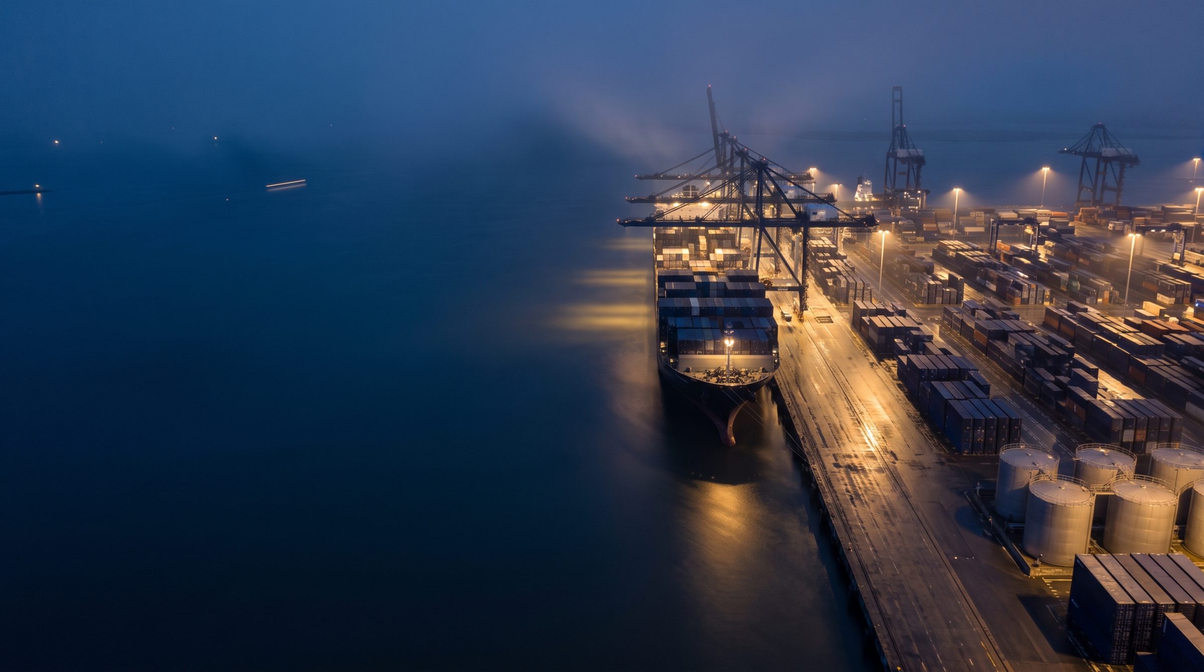Container ship loading at the port at dawn